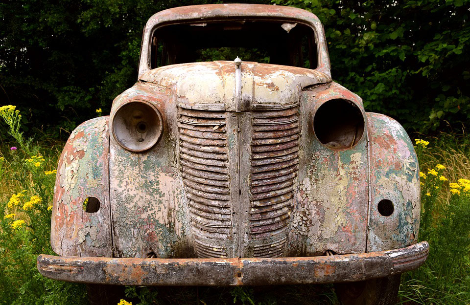 Old car in field of flowers